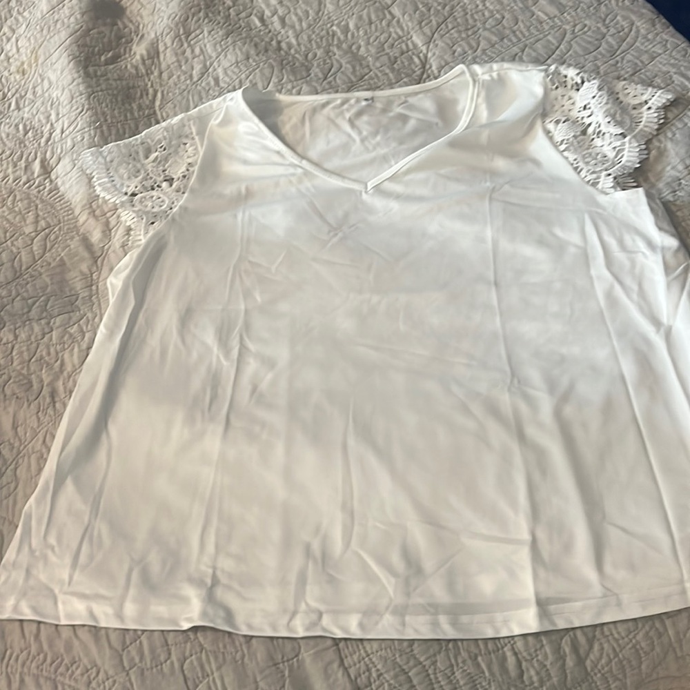 Light, white with lace caplet sleeves.  Material is breathable & airy.